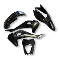 Set of black motorcycle body panels on a white background
