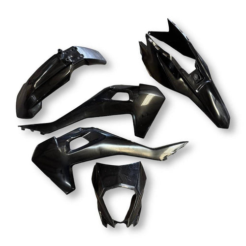 Set of black motorcycle body panels on a white background